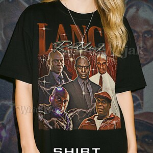May include: Black unisex t-shirt featuring a graphic of several men in suits and casual wear with the text "Lanc Redlick Mujak". The shirt also has the word "Shirt Unisex" in white text.