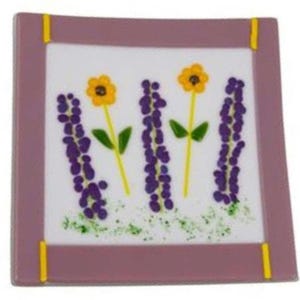 Decorative white and purple glass plate   with  purple and  yellow flowers.