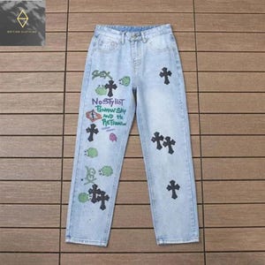Vintage Graffiti Cross Patch Jeans – Light Blue Streetwear Denim for Men & Women
