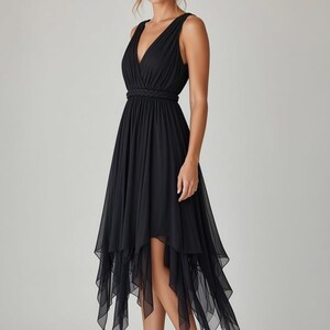 May include: A black sleeveless dress featuring a V-neckline, a braided waistband, and a layered handkerchief hemline. The skirt is constructed from sheer, flowing fabric that falls to varying lengths, creating a dynamic silhouette.