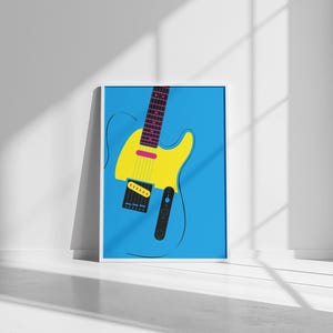 May include: A framed art print featuring a stylized electric guitar. The guitar has a yellow body, a pink accent, and a black pickguard. The background is a solid light blue, and the frame is white.