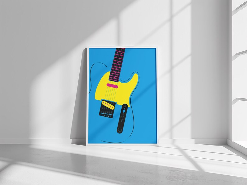 May include: A framed art print featuring a stylized electric guitar. The guitar has a yellow body, a pink accent, and a black pickguard. The background is a solid light blue, and the frame is white.