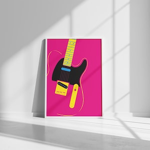 May include: A framed art print featuring a stylized electric guitar illustration. The guitar is black with yellow and blue accents, set against a vibrant pink background. The artwork is displayed in a white frame.
