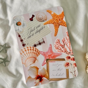 May include: A notebook with a beach-themed collage design. It includes an orange starfish, seashells, coral, and flowers. The text "Just one more chapter" and "Can't you see that I'm booked?" are displayed on the cover.