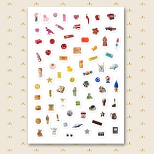 May include: A sheet of colorful stickers featuring various designs, including a red telephone, a pink dinosaur, a smiley face, a hamburger, a camera, and a teddy bear. The stickers are arranged on a white background.
