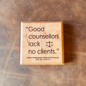 May include: Wooden sign with a quote from William Shakespeare's Measure for Measure: "Good counsellors lack no clients."