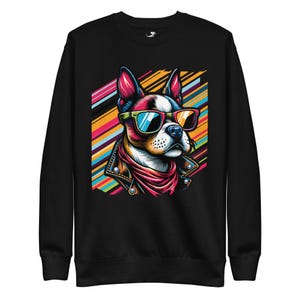 May include: Black sweatshirt featuring a colorful illustration of a dog wearing sunglasses, a leather jacket, and a red scarf. The dog is set against a backdrop of colorful diagonal stripes. The sweatshirt is made of a soft material.