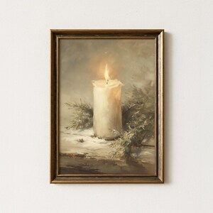 May include: A framed oil painting depicting a single lit white pillar candle centered among green pine branches. The candle flame glows with a warm yellow light, casting soft shadows on a textured surface. The frame is a dark metallic bronze color.