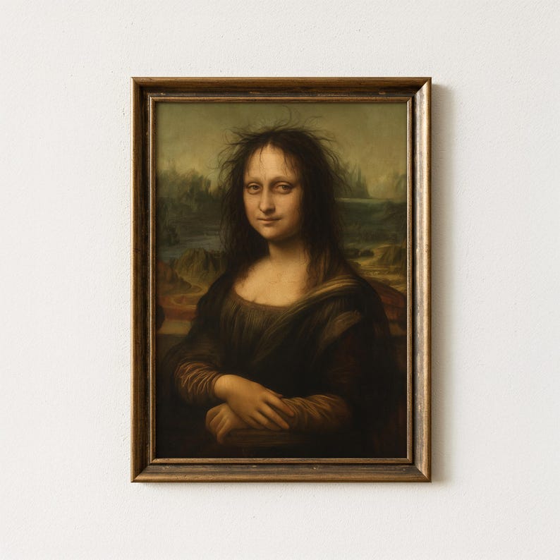 May include: Framed print of a parody of the Mona Lisa. The subject has messy hair and a slightly amused expression. The artwork is set against a landscape background and framed in a gold-toned wooden frame.