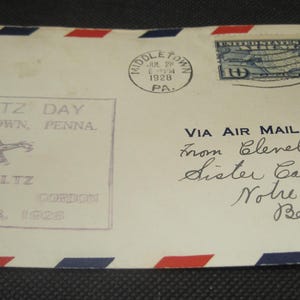 May include: Vintage airmail envelope with red, white, and blue trim. The envelope is postmarked Middletown, PA, July 26, 1928, and addressed to Sister Carmela in Belmont, Calif. Features a stamp and text: "STULTZ DAY, Middletown, Penna."