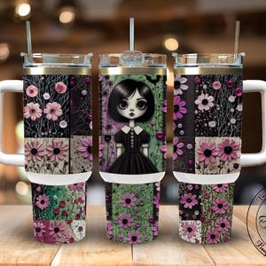 May include: Three stainless steel travel mugs with white handles and lids. The mugs feature a floral design with pink flowers and a gothic girl illustration. The mugs are decorated with a variety of floral patterns and a black background.