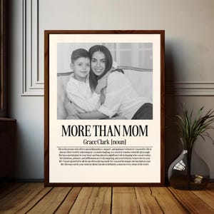 May include: A framed black and white print featuring a mother and child. The print has the text "MORE THAN MOM" and a definition of the word "mom". The frame is a dark brown color.