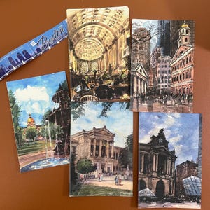 May include: A collection of five rectangular watercolor postcards featuring Boston landmarks, including a library interior, city street scenes, a park fountain, and a museum exterior, accompanied by a blue Boston 2026 World Expo souvenir strip.