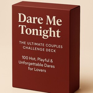 May include: A maroon box with white text that reads "Dare Me Tonight." The box also states "THE ULTIMATE COUPLES CHALLENGE DECK" and "100 Hot, Playful & Unforgettable Dares for Lovers."