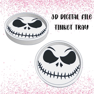 May include: Two white, circular trinket trays featuring a Jack Skellington face design. The trays have a raised edge and a smiling face with black eyes and mouth. The text "3D DIGITAL FILE TINKET TRAY" is in black script.
