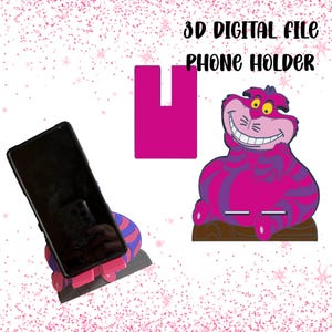 Könnte beinhalten: Ein Telefonhalter mit einem Design der Grinsekatze aus Alice im Wunderland. Der Halter ist rosa und lila, mit einem schwarzen Telefon. Der Text lautet "3D DIGITAL FILE PHONE HOLDER".