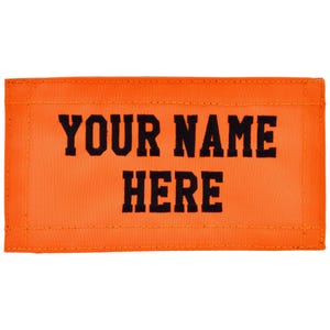 May include: Bright orange rectangular patch with the text "YOUR NAME HERE" in bold black letters. The patch has a stitched border and a lighter orange center.