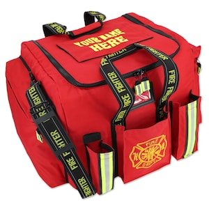 May include: A red firefighter's gear bag with black accents and multiple pockets. The bag features the text "YOUR NAME HERE" and "FIRE FIGHTER" in yellow. A fire department emblem is visible on the front.