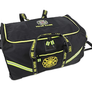 May include: Black rolling duffel bag with yellow accents and reflective stripes. Features the text "FIRE FIGHTER" on the straps and "FIRE DEPT" with a Maltese cross logo. Includes a top handle and a retractable handle.