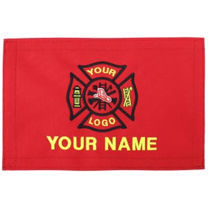 May include: A red rectangular patch with a black and yellow firefighter emblem. The emblem includes a Maltese cross design with a firefighter's hat in the center. The text "YOUR LOGO" and "YOUR NAME" are in yellow.