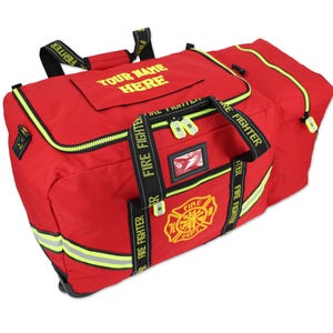 May include: Red firefighter duffel bag with black accents and yellow reflective stripes. Features the text "YOUR NAME HERE" and "FIRE FIGHTER". Includes a yellow and black fire department emblem.