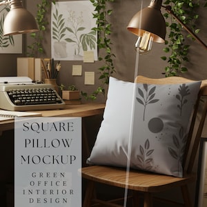 May include: A square pillow mockup with a grey leaf and circle pattern, displayed on a wooden chair. The image includes a vintage typewriter, desk lamp, and the text "SQUARE PILLOW MOCKUP GREEN OFFICE INTERIOR DESIGN."