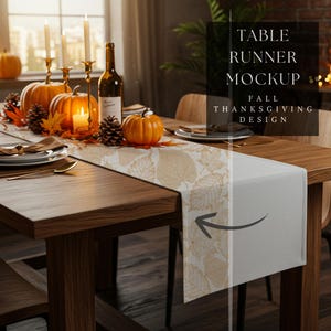 May include: A wooden table set for a fall Thanksgiving dinner. The table is decorated with pumpkins, candles, a table runner with a leaf design, and place settings. The text on the table runner says "TABLE RUNNER MOCKUP FALL THANKSGIVING DESIGN."