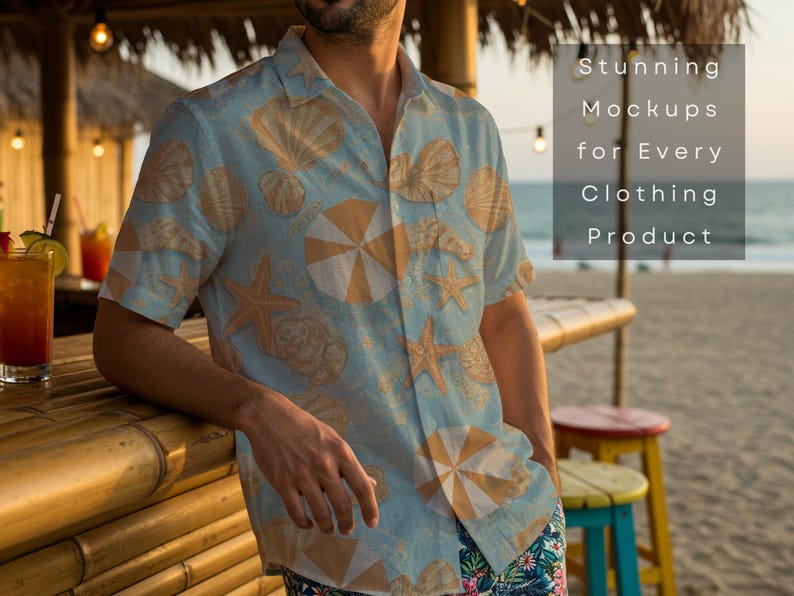 May include: A light blue button-down shirt with a seashell and umbrella pattern. The shirt is part of a clothing product mockup. The text on the image reads "Stunning Mockups for Every Clothing Product". The shirt is worn at a beach bar.
