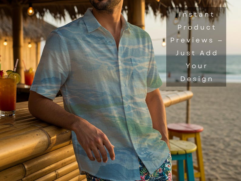 May include: A short-sleeved button-down shirt with a blue and green watercolor design. The shirt is worn by a person leaning on a bamboo bar. The text on the image reads "Instant Product Previews - Just Add Your Design."