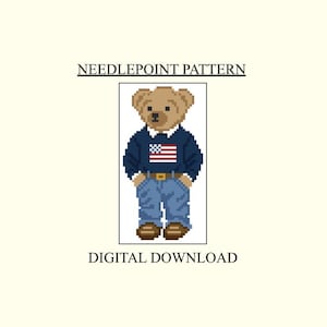 May include: A pixel art needlepoint pattern digital download featuring a light brown teddy bear wearing a navy blue sweater with a small American flag graphic, blue jeans with a yellow belt, and brown shoes. The text reads NEEDLEPOINT PATTERN and DIGITAL DOWNLOAD.