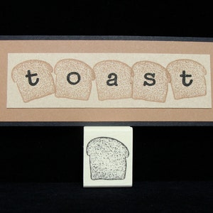 May include: A brown card with the word "toast" spelled out using individual bread slices. Each slice has a letter printed on it. Below the card is a single bread slice stamp.