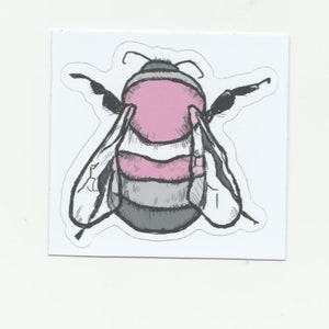 May include: A sticker of a cartoon bee with pink, white, and gray stripes. The bee has black eyes and antennae.
