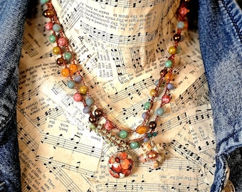 Adjustable beaded lariat charm necklace.