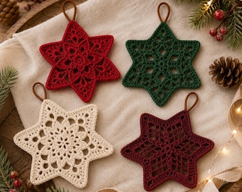 May include: Four star-shaped ornaments crafted from crochet thread, featuring intricate lace-like patterns. The set includes one bright red, one dark green, one cream, and one deep burgundy star, each equipped with a small brown hanging loop.