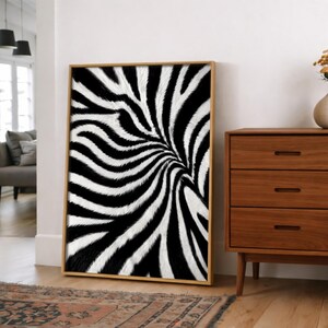May include: A rectangular wall art print featuring a high-contrast black and white zebra stripe pattern. The artwork is encased in a light-toned wooden frame and displays a repeating, organic, and flowing design of monochromatic animal fur stripes.