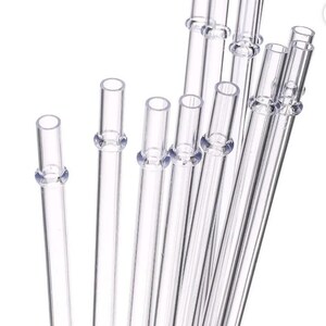 May include: A collection of clear glass straws, each with a slightly flared top and a small ring detail near the top. The straws are arranged at various angles against a white background, showcasing their transparency and simple design.
