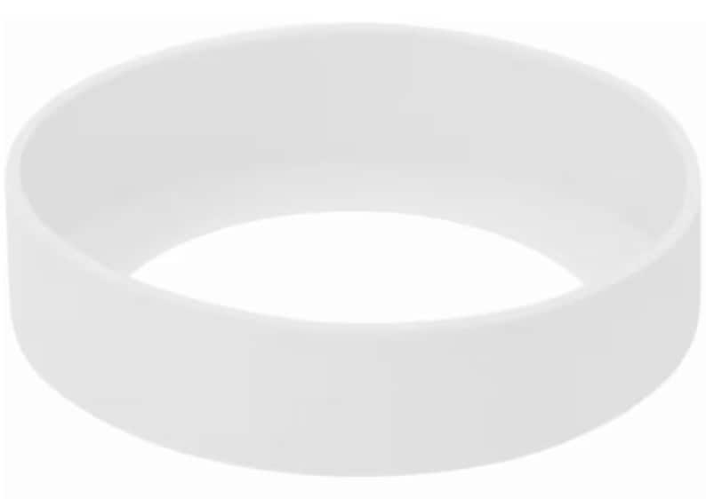 May include: A solid white, circular silicone bracelet. The bracelet is a simple, minimalist design, with a smooth, matte finish. The band is approximately 1 inch wide.