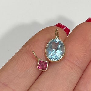 Very Brilliant Oval Blue Topaz in Solid 14K Yellow Gold Bezeled Pendant