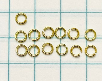 Lote de 13 anillos de salto abiertos de oro amarillo macizo de 14 quilates de 3 mm y 24 g de calibre 24