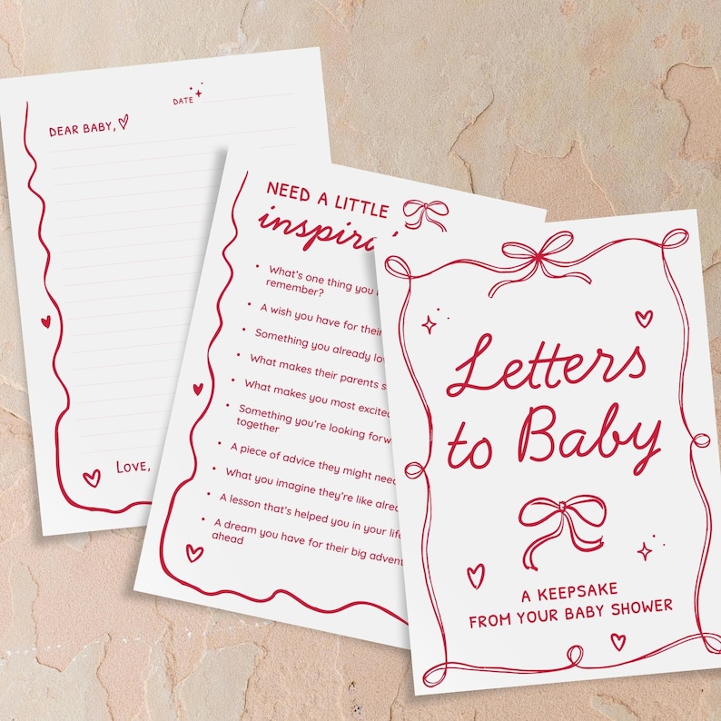 May include: A set of baby shower stationery with red accents. The set includes a lined letter sheet with the text "Dear Baby" and "Love," and two cards. One card reads "Letters to Baby" and the other has prompts.