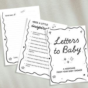 May include: A set of three white paper cards with black handwritten text and decorative borders. The cards include prompts for baby shower guests to write letters to the baby, with phrases like "Letters to Baby" and "Dear Baby."