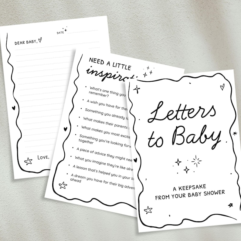 May include: A set of three white paper cards with black handwritten text and decorative borders. The cards include prompts for baby shower guests to write letters to the baby, with phrases like "Letters to Baby" and "Dear Baby."