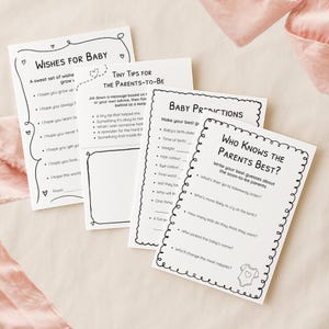 Könnte beinhalten: Eine Sammlung weißer Papierkarten mit schwarzem Text, die für eine Babyparty entworfen wurden. Die Karten enthalten Aufforderungen für Wünsche, Ratschläge und Vorhersagen. Die Karten sind mit einfachen schwarzen Strichzeichnungen verziert.