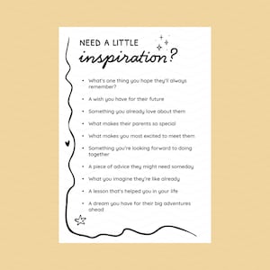 May include: A white card with the text "NEED A LITTLE inspiration?" in a handwritten font. Below, a list of prompts includes questions about memories, wishes, and advice. The card is decorated with stars, a heart, and a star-shaped doodle.