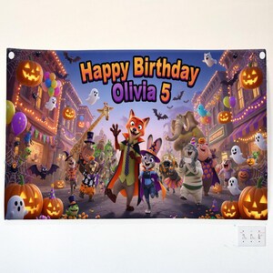 May include: A rectangular birthday banner featuring Zootopia characters in Halloween costumes on a city street. The text reads Happy Birthday Olivia 5. The scene includes jack-o'-lanterns, ghosts, bats, and colorful balloons against a dark night sky.
