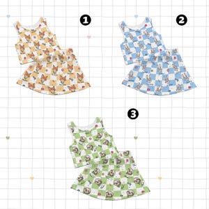 May include: Three sets of children's clothing, each consisting of a tank top and a skirt. The first set is orange and white with fox graphics. The second set is blue and white with bunny graphics. The third set is green and white with sloth graphics.