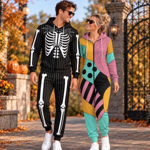 May include: A black hooded sweatshirt and matching sweatpants featuring a white skeleton ribcage and bone print. Beside it, a multicolored zip-up jumpsuit with a patchwork pattern of pink, yellow, black, and teal sections with black stitch details.