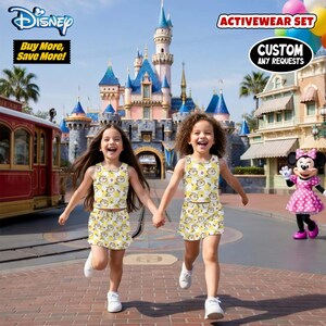 May include: Two young girls wearing matching yellow activewear sets with a cartoon character print run toward the camera. The background features a castle, a trolley, and a Minnie Mouse character. The image includes the text "Disney", "Buy More, Save More!", "Activewear Set", and "Custom Any Requests."