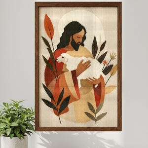 Puede incluir: Patrón de punto de cruz de una figura religiosa sosteniendo un cordero, enmarcado en madera oscura. La obra de arte presenta una paleta de colores cálidos con tonos de naranja, marrón y beige. El texto "Cross Stitch Pattern" está en la parte superior.