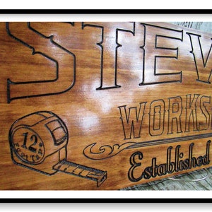 May include: A wooden sign with the text "Steve's Workshop Established 20" and a stylized image of a tape measure with the number "12" on it.
